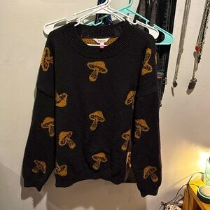 It’s just a black and brown mushroom sweater, it’s very nice and pretty warm